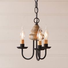 a chandelier with three lights hanging from it