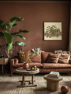 a living room filled with furniture and a large plant in the middle of the room