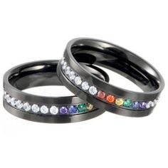 two black rings with rainbow stones on them