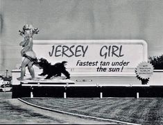 an advertisement for jersey girl on the side of a road with a dog running in front of it