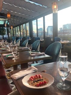 a plate of food on a table with wine glasses and water in front of it