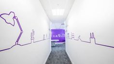 an empty hallway with purple and white walls