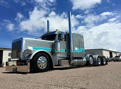 a large semi truck parked in front of a building