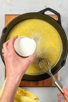 a person is mixing some food in a pot