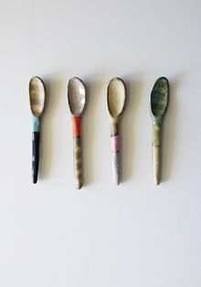 five spoons are lined up in a row