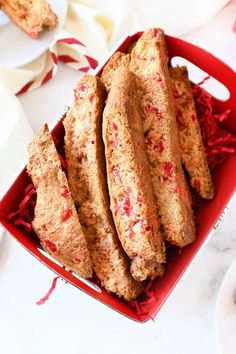 a red box filled with cookies on top of a table