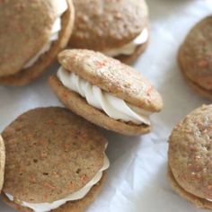 several cookies with white frosting and carrots on them