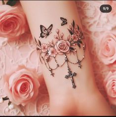 a close up of a person's foot with tattoos on it and roses in the background