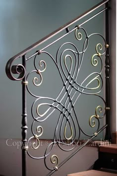 an iron stair railing with decorative designs on it