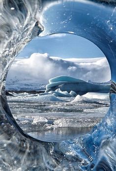 an iceberg is seen through a hole in the water