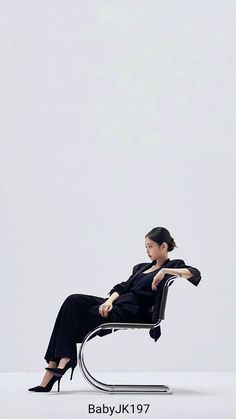 a woman sitting in a chair with her legs crossed