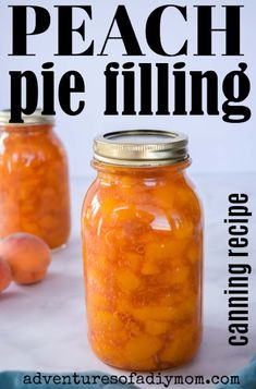 two jars filled with peach pie filling on top of a table