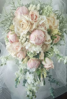 a bridal bouquet with pink and white flowers