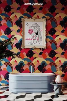 the bathroom is decorated with colorful wallpaper and an art work on the wall above it