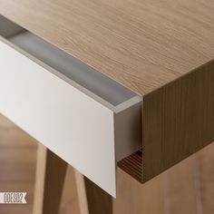 a close up view of a wooden table with drawers on each side and an open drawer in the middle