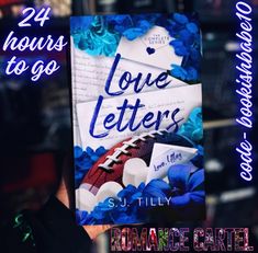 a book with the title love letters written on it and flowers in front of it