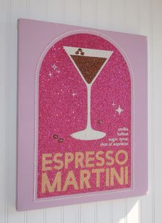 a pink sign that says espresso martini on the side of a white wall