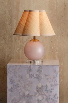 Add a whimsical yet sophisticated touch to your Valentine’s Day décor with the Pink Dottie Table Lamp. The handblown blue glass base, paired with crystal-clear acrylic, brings a playful elegance to any room. Topped with a hand-trimmed, softly scalloped raffia shade, it exudes a soft, romantic glow. Perfect for a bedroom, family room, or entryway, it’s a fun and functional way to brighten your space this February. #ValentinesDayDecor #RomanticLighting #TableLamp #PinkDecor #SoftGlow Eclectic Lamp, Pink Eclectic, Eclectic Lamps, Romancing The Stone, Pink Table Lamp, Romantic Lighting, Bedroom Lamps, Small Moments, Pink Bedroom