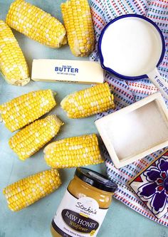 corn on the cob, butter, and other ingredients laid out on a table