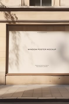 an empty window poster mockup on the side of a building in front of a tree