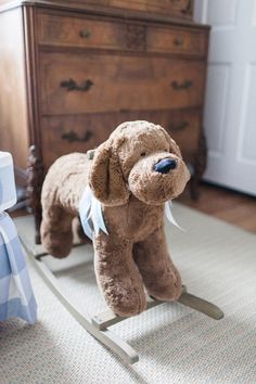 a stuffed dog is sitting on a rocking toy