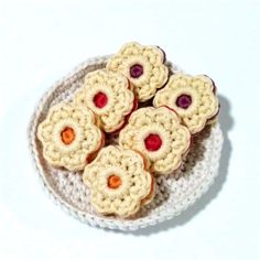 small crocheted cookies sitting on top of a white plate