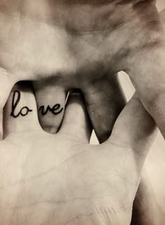 two hands holding each other with the word love written on them