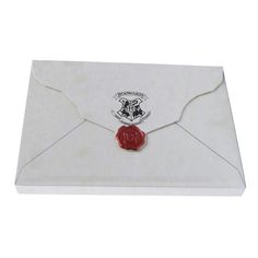 a white envelope with a red wax stamp on the front and an emblem on the back