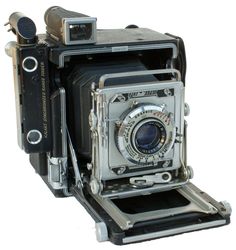 an old fashioned camera sitting on top of a table