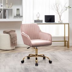 a pink office chair sitting on top of a wooden floor next to a white rug