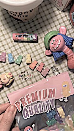 a person holding a candy bar next to a bowl of candies on a table