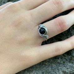 This steel black onyx ring is durable and hypoallergenic. Simple gothic style that will last. The stone is 6mm.  Comes in a gift box. Rings may appears larger in photos to show detail. Since each ring is handmade and stone vary in color tone and pattern, there may be slight differences in each ring. Returns and exchanges are accepted within a reasonable time frame. Always feel free to contact me with any questions or special requests. Facebook Page : http://www.facebook.com/DistortedEarth look for me on TikTok @Distorted_Earth Follow me on Instagram @distortedearth Thank you! -Brandy Black Birthstone Rings For Gifts, Black Birthstone Jewelry For Promise Ring, Black Birthstone Rings, Gothic Stainless Steel Ring As A Gift, Black Crystal Ring With Gemstone For Gift, Black Crystal Gemstone Ring For Gift, Gothic Black Stainless Steel Rings, Minimalist Black Metal Rings, Black Open Ring Metal Rings