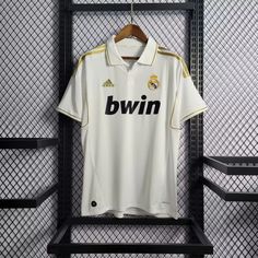 a soccer jersey hangs on a rack in the dressing room at real madrid's new stadium