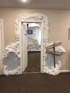 the entrance to an ice cave is decorated with fake snow