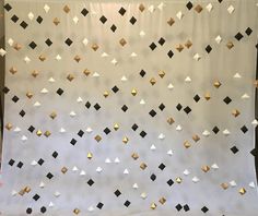 a white backdrop with gold and black squares on it