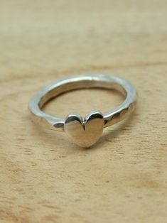 Sterling silver heart ring. This chunky heart ring  has been created in our own studio in Cornwall. The heart is hand saw pierced and sits on a hammered silver band. Looks great and is very comfortable to wear. UK finger sizes  J to T Other sizes  on request    All my jewellery comes in a presentation gift box.  All my designs are hand made and no two are exactly the same.   Thank you for visiting. Wedding Rings Heart, Bridesmaid Ring, Rings Heart, Silver Leaf Ring, Heart Wedding Rings, Bridesmaid Rings, Silver Flower Ring, Wholesale Silver Jewelry, Silver Rings With Stones