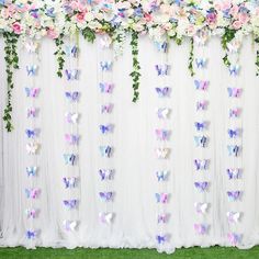 the backdrop is decorated with flowers and butterflies