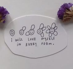 some flowers are sitting on top of a white plaque with writing that says, i will love my self in every form