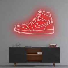 a neon nike shoe is shown on the wall