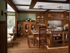 a large kitchen with wooden cabinets and wood flooring, along with an island in the middle