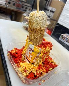 an ice cream sundae in a plastic container filled with cereal and other toppings