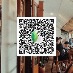 people sitting at tables with qr code on them