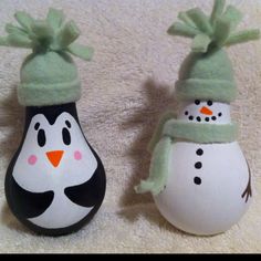 two snowmen are sitting next to each other on the carpet, one is wearing a green hat