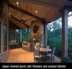 a covered porch with fireplace and outdoor kitchen