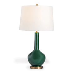 a green table lamp with a white shade on the base and a gold metal base