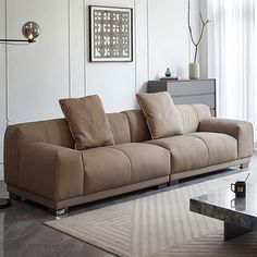 a living room with a couch, coffee table and two lamps on the side tables