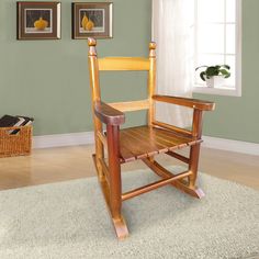 a wooden rocking chair sitting on top of a rug