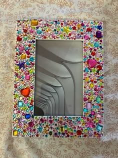 a multicolored glass frame with hearts on it