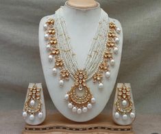 Beautiful kundan necklace set with danglers. The necklace is adjustable to your desired length with rope dori. Perfect for wedding, engagement, parties or special occasions. The set is beautifully designed to complement any outfit, adding a touch of elegance and sophistication to your look.  The necklace set makes for an ideal gift for yourself or a loved one. All the raw material used in this product is of high quality and is handcrafted with love. Color, shades, texture displayed may slightly vary from the actual product due to digital image limitations. Care: It is advisable that you keep our products away from water, perfume, direct heat, humidity and other chemicals. Clean it with soft cloth. Contact us for any question or live video of the necklace set. Temple Jewelry Kundan With Dori Work, Kundan Temple Jewelry With Dori Work, White Bridal Necklace With Gota Work As Gift, White Bridal Necklace With Gota Work For Gift, White Bridal Necklace With Mirror Work As Gift, White Kundan Necklace With Mirror Work As Gift, Gift White Kundan Necklace With Mirror Work, Heavy White Kundan Necklace For Puja, Temple Style Kundan Necklace With Dori Work As Gift