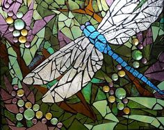 a dragonfly sitting on top of a flower next to bubbles and water droplets in a stained glass window